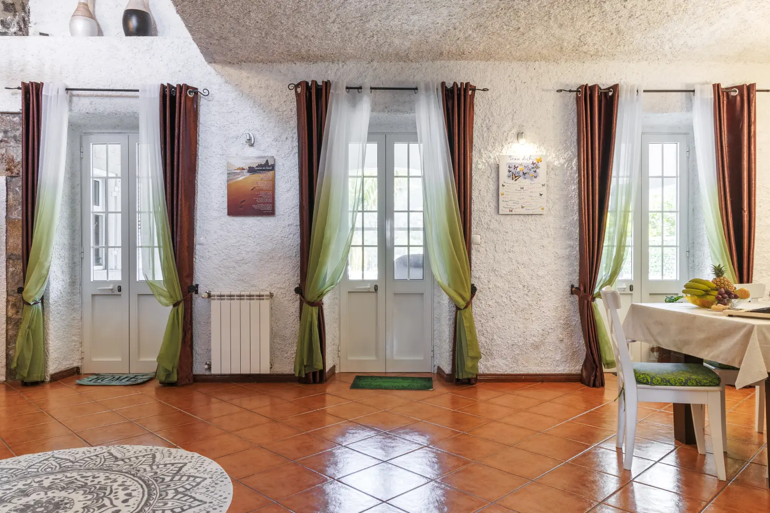 Villa Magia Verde – Blick auf ein Zimmer mit wunderschönen Wandbildern und Vorhängen